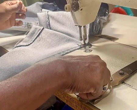 Tailor skillfully using specialized scissors to trim fabric before stitching Stock Photos