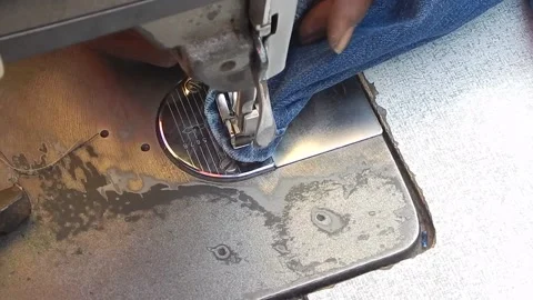 Tailor stitching jeans pant in day light Stock Footage 149304351