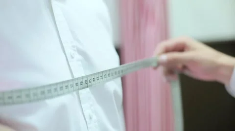 Tailor takes measurements from the man Stock Footage 68052738
