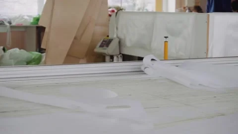 Tailor takes textile details from cutting table at factory Stock Footage 236908392
