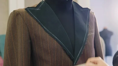 Tailor taking measures with measuring tape on a mannequin Stock Footage 106231564