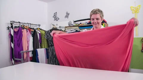 Tailor throwing fabric over big table in slow motion wide shot Stock Footage 41012129