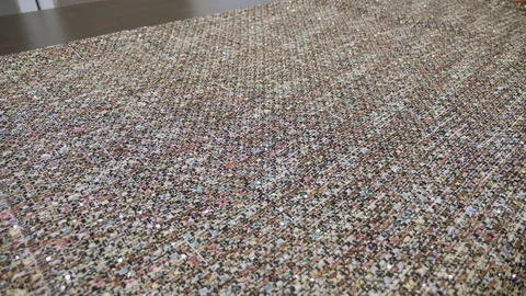 Tailor throwing fabric over big table in slow motion wide shot Stock Footage 101546049