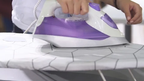 Tailor is using iron for press on fabric Stock Footage 99035683