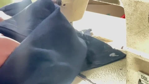 Tailor Using Sewing Machine To Stitch Blue Denim Pant Stock Footage 312318130
