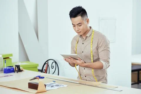 Tailor watching tutorial on tablet 写真素材