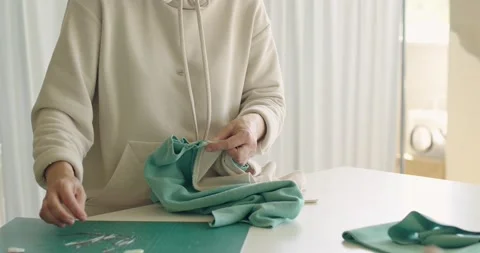 Tailor woman stitching fabric pattern between each other with pins at sewing Stock-Footage 201196163