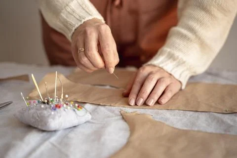 Tailor woman using needle thread sew Stock Photos