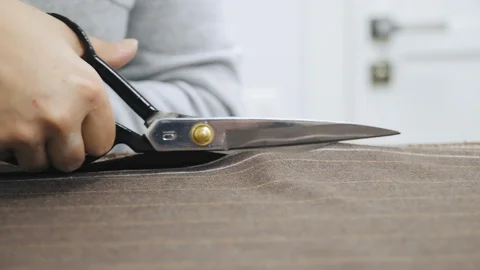 Tailor at work. Cutting suit fabric with scissors Stock Footage 106193113