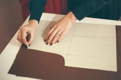 Tailor at work, drawing line on fabric with chalk Stock Photos