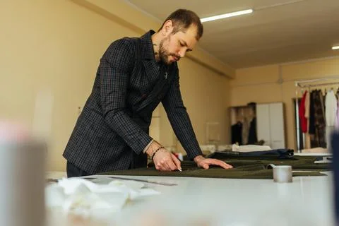 Tailor at work, drawing line on fabric with chalk Stock Photos