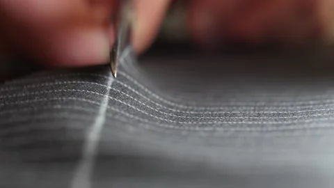 Tailor work: Process of creating from wool fabric cutting along the tailor chalk Stock Footage 138736400