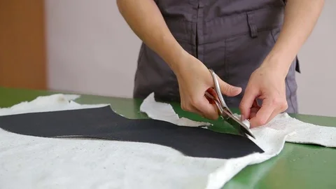 Tailor Working In The Laboratory With Scissors On Table Video stock 82917464