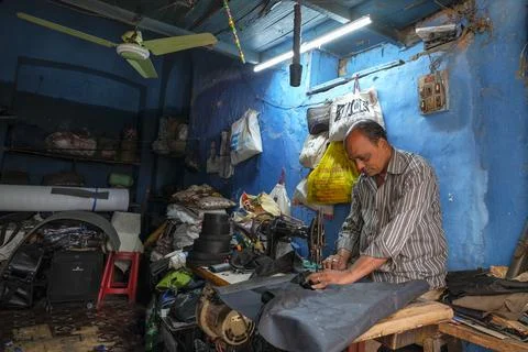 A tailor working with a sewing machine Stock Photos