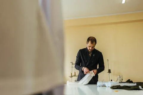 Tailor working at studio cutting fabric, detail of hand with scissors Stock Photos
