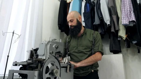 A Tailor works on his eyelet buttonhole machine. Stock Footage