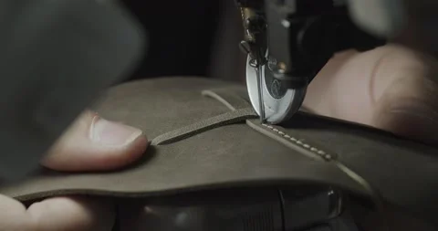 Tailor works on sewing machine in private leather craftshop, making shoes in Video stock 200127399