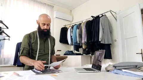 Tailor works with sketches in his workshop. Stock Footage 80734114
