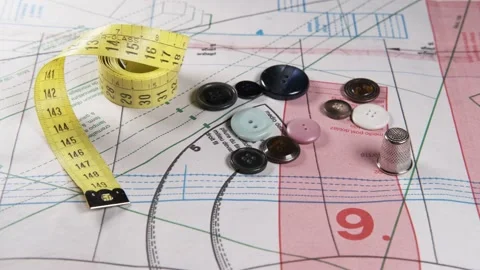 Tailoring accessories, measuring tape, buttons, patterns, on work table Видео 148182790
