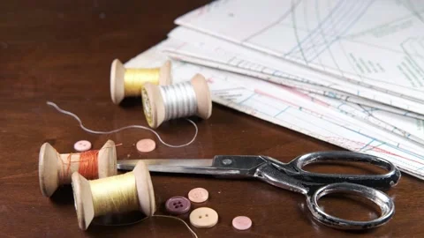 Tailoring accessories, tailor's scissors, models, spools of thread on the table Stock Footage 147722517