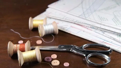 Tailoring accessories, tailor's scissors, models, spools of thread on the table Stock Footage 147724990