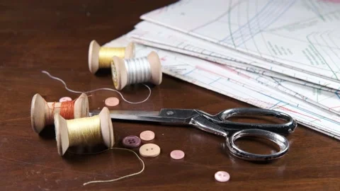 Tailoring accessories, tailor's scissors, models, spools of thread on the table Stock Footage 147726509