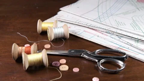 Tailoring accessories, tailor's scissors, models, spools of thread on the table Stock Footage 147727162