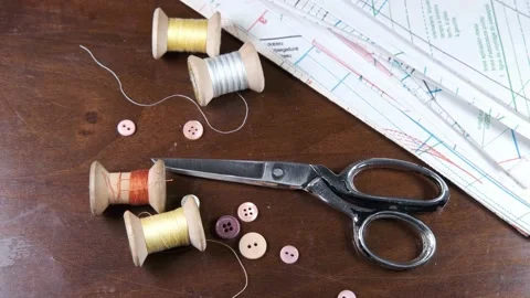 Tailoring accessories, tailor's scissors, models, spools of thread on the table Stock Footage 147728436