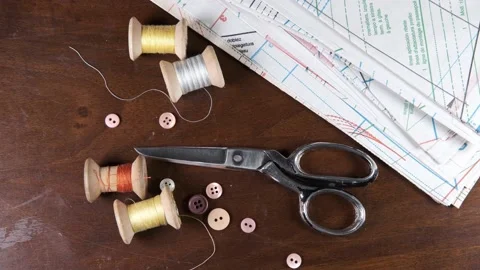 Tailoring accessories, tailor's scissors, models, spools of thread on the table Stock Footage 147729512