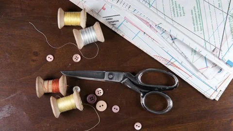 Tailoring accessories, tailor's scissors, models, spools of thread on the table Stock Footage 147730295