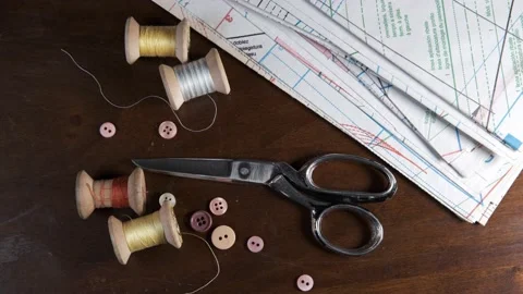 Tailoring accessories, tailor's scissors, models, spools of thread on the table Stock Footage 147731775