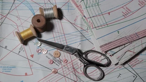 Tailoring accessories, tailor's scissors, models, spools of thread on the table Stock Footage 147733482