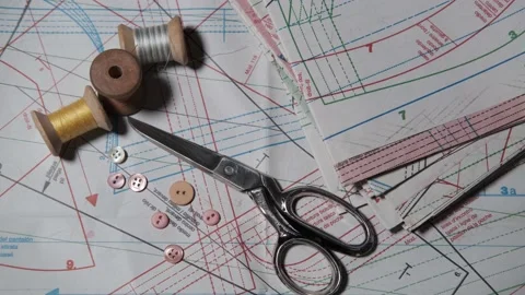 Tailoring accessories, tailor's scissors, models, spools of thread on the table Stock Footage 147733532