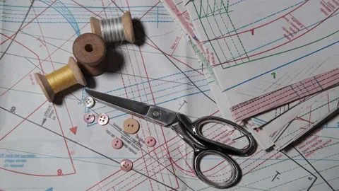 Tailoring accessories, tailor's scissors, models, spools of thread on the table Stock Footage 147735937