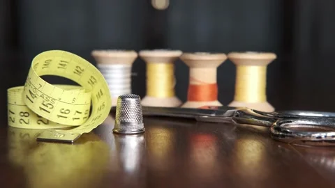 Tailoring accessories, tailor's scissors, models, spools of thread on the table Stock Footage 148056478