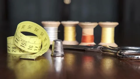 Tailoring accessories, tailor's scissors, models, spools of thread on the table Stock Footage 148056947