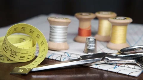 Tailoring accessories, tailor's scissors, models, spools of thread on the table Stock Footage 148057745