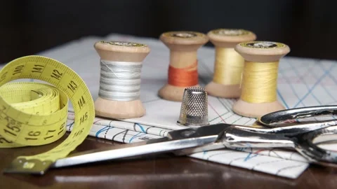 Tailoring accessories, tailor's scissors, models, spools of thread on the table Stock Footage 148058001