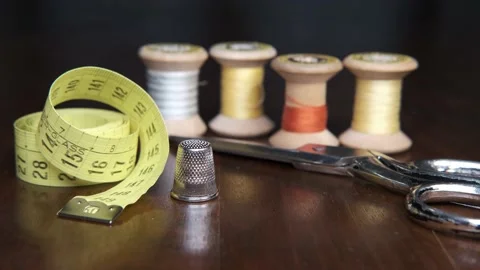 Tailoring accessories, tailor's scissors, models, spools of thread on the table Stock Footage 148058408