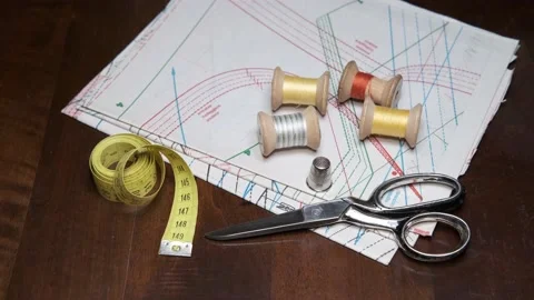 Tailoring accessories, tailor's scissors, models, spools of thread on the table Stock Footage 148058924