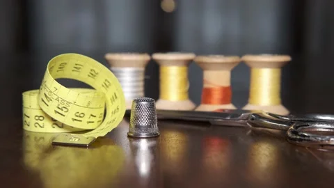 Tailoring accessories, tailor's scissors, models, spools of thread on the table Видео 148069100