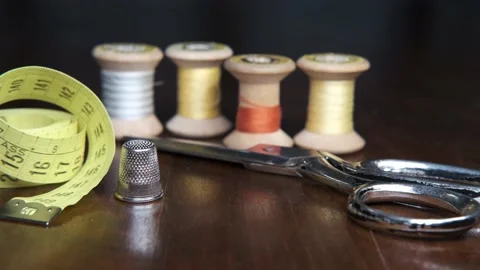 Tailoring accessories, tailor's scissors, models, spools of thread on the table Видео 148070200