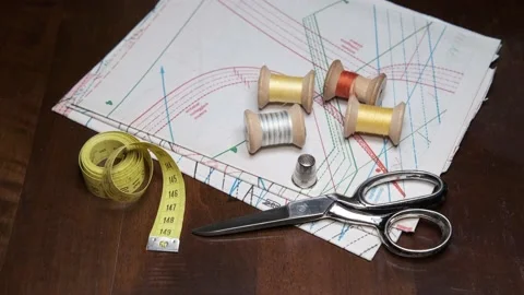 Tailoring accessories, tailor's scissors, models, spools of thread on the table Видео 148083410