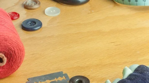 Tailoring Close Up - moving sewing accessories on wooden desk, stop motion Stock Footage 103627542