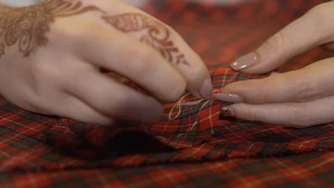 Tailoring concept. Hands of a tailor who sews with a needle and thread by hand Stock Footage 88758391