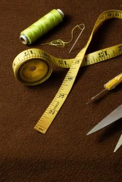 Tailoring materials on a brown background Stock Photos