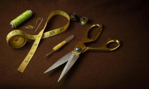 Tailoring materials on a brown background Stock Photos