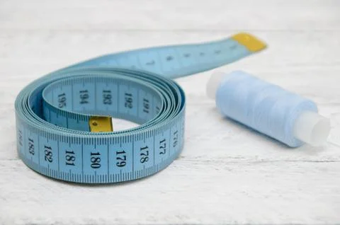 Tailoring meter and sewing thread on white boards Stock Photos