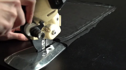 Tailoring process. Cutting cloth with electric circular knife Stock Footage 104539721