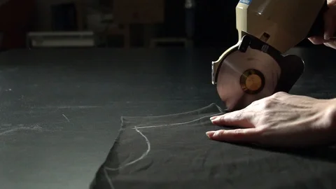 Tailoring process. Cutting cloth with electric circular knife Stock Footage 104539861